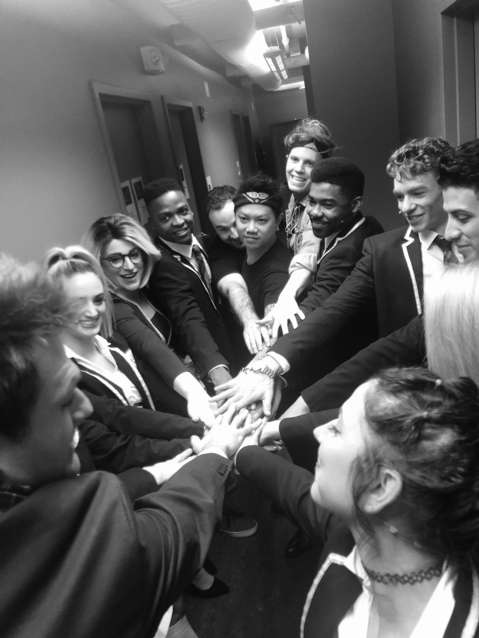 Kenneth Ferrone and a company gathering in a rehearsal-room huddle