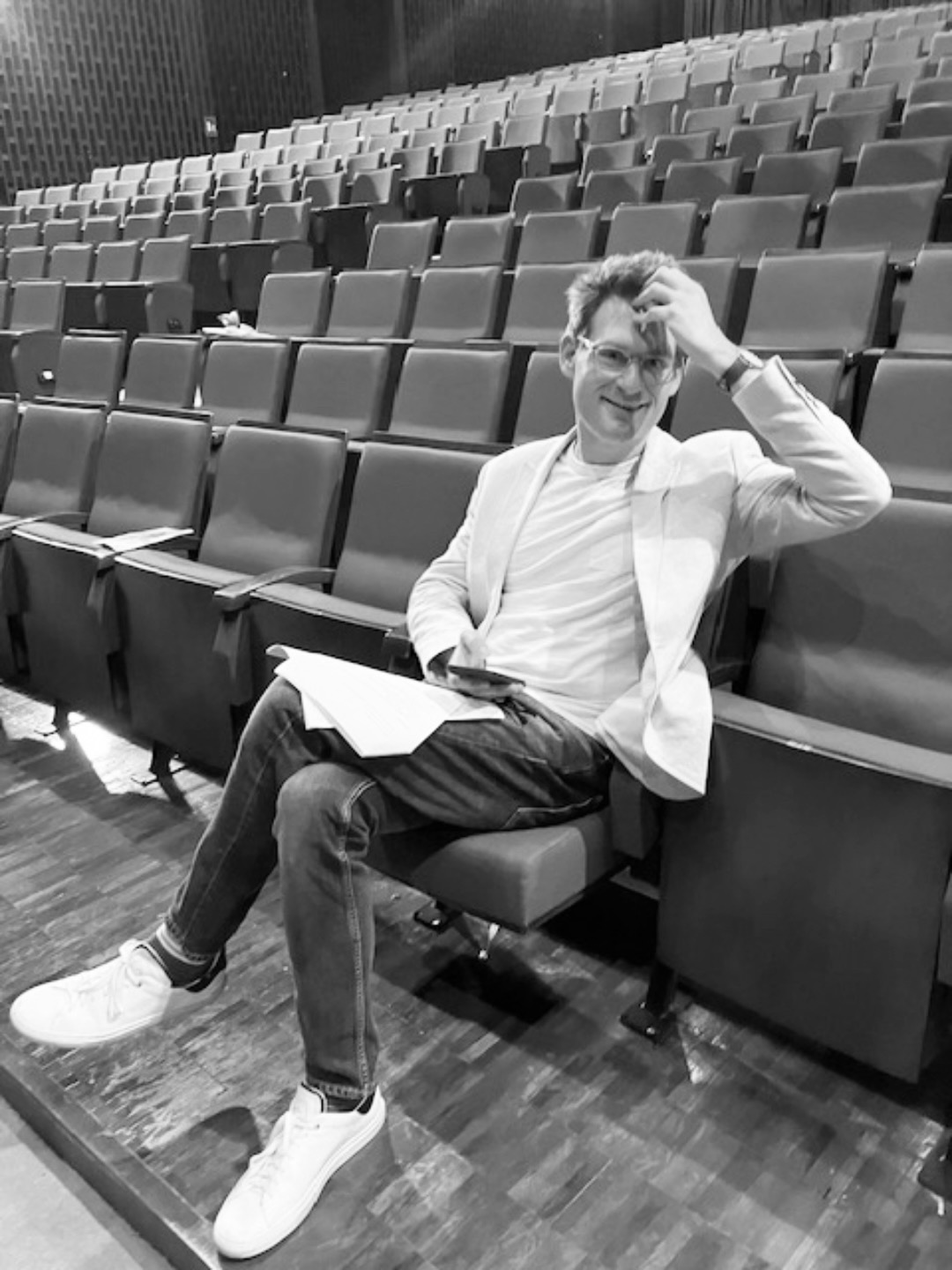 Kenneth Ferrone seated in a theatre during production